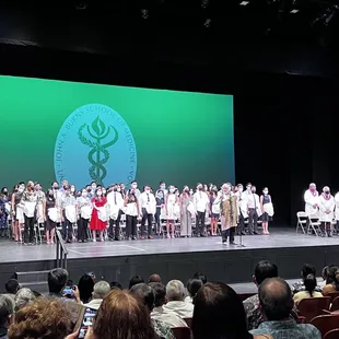 Dr Brady performs a Hawaiian chant with the JABSOM Class of 2024.