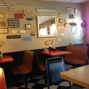 Cute signs on the wall and cozy seating.