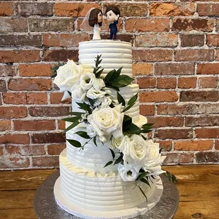 a wedding cake with white flowers