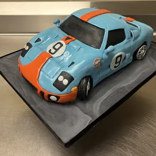 a blue and orange race car cake