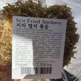 a hand holding a container of rice