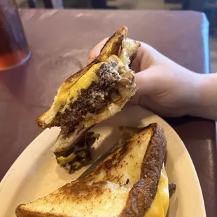 a grilled cheeseburger and french fries