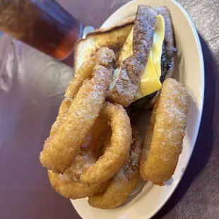 a plate of onion rings and a drink
