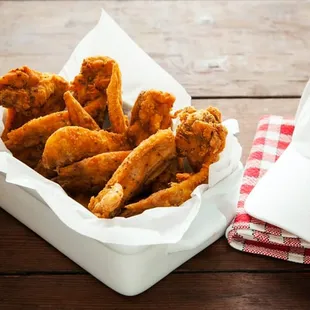 a basket of fried chicken and a hat