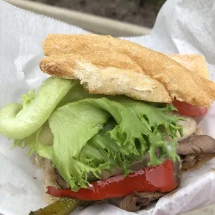 a hand holding a sandwich