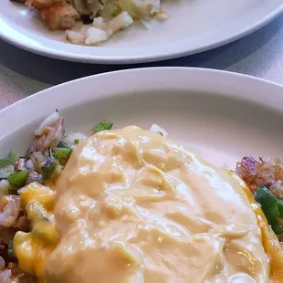 Everything hashbrowns... one with hollandaise and one with sausage gravy.