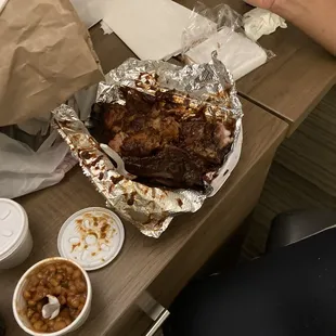 Combination plate two pork ribs, two tasty beef ribs and a mound of tender brisket and two slices of white bread.