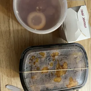 The packaging for the General Tso&apos;s Shrimp, a rubber band was used to avoid spillage. Very large portion.