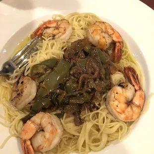 a plate of noodles with shrimp and peppers