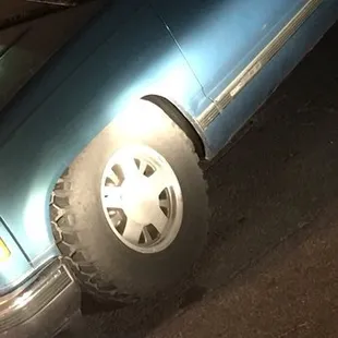 This is before the tow truck driver arrived notice how the tire isn't slanted and there is no marks on the road