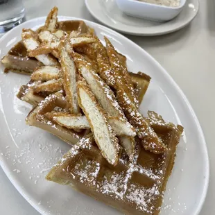 a plate of waffles and french fries