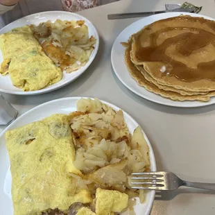 Meat lovers omelette, western omelette, and full order of pancakes