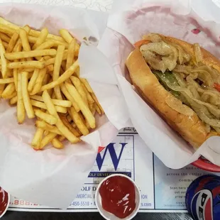 jumbo vegan hot dog, french fries, and a canned soda