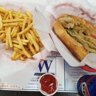 jumbo vegan hot dog, french fries, and a canned soda