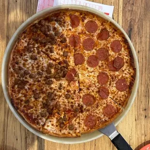 a pepperoni pizza on a pan