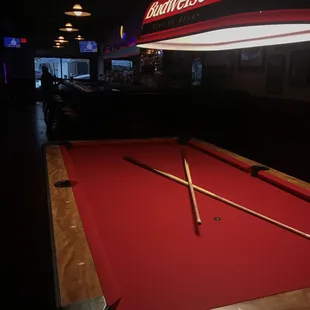 a pool table with a red cloth