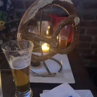 a pretzel and a glass of beer
