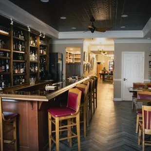 a bar with red chairs