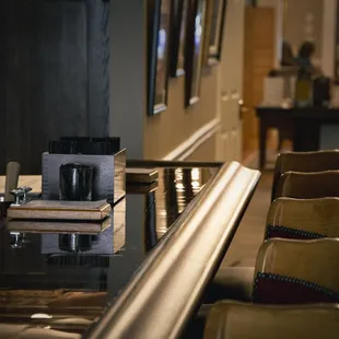 a bar with chairs and a coffee maker