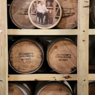 a man standing in front of barrels