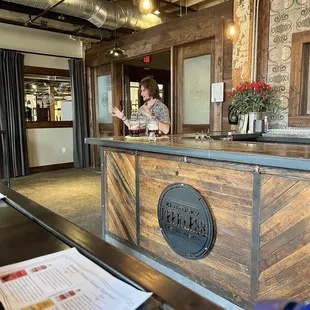 a woman standing at a bar