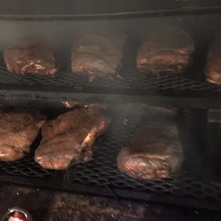 steaks cooking on a grill