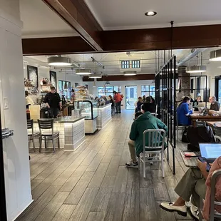 people sitting at tables in a restaurant
