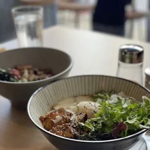 two bowls of food on a table