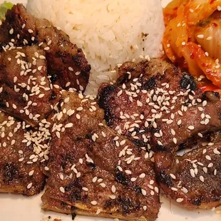 a plate of food with rice and meat