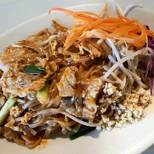 Pad Thai  Stir-fried Thai rice noodle with pork, egg, ground peanuts, bean sprouts, green onions and carrots.