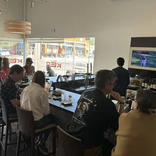 Happy hour with full bar except for 4 seats taken by people sitting outside.
