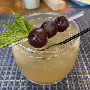 a drink with grapes and mint