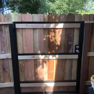 Steel framed wall-through gate