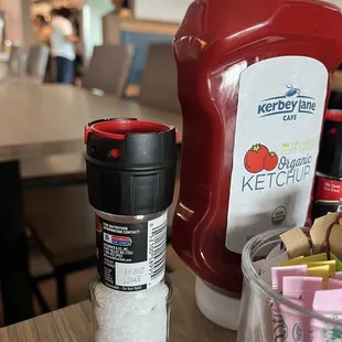 a ketchup container and a container of ketchup