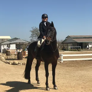 Alexis ridding Feline waiting for her class.