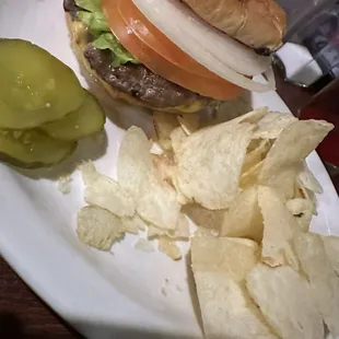 a hamburger and chips on a plate