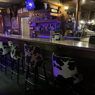 bar with cow print chairs