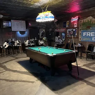 a pool table in the middle of the room