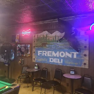 a pool table and neon signs