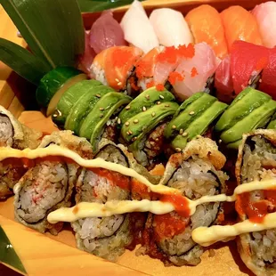 a variety of sushi on a wooden platter