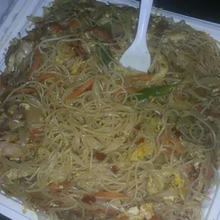 a plate of noodles with meat and vegetables
