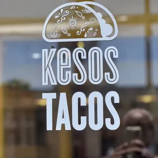 a man taking a picture of a taco