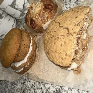 Stack is I&apos;m assuming pumpkin, then a chocolate chip pecan, and two iced oatmeal cookies. The pecan muffin and oatmeal cookie sandwich.