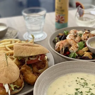 Oyster po boy, clam chowder, and mixed green salad with grilled shrimp.