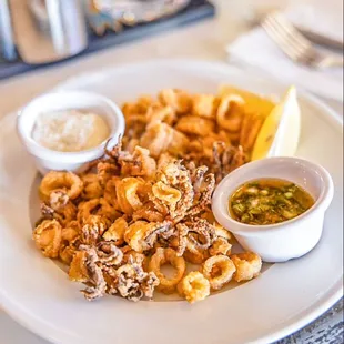 While pepper calamari with citrus-cider dipping sauce and paprika tartar sauce