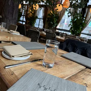a wooden table with a glass of water
