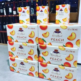 a stack of boxes of peach wine