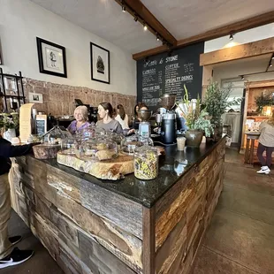 a coffee shop counter with a variety of items on it