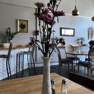 a vase of flowers and salt shakers