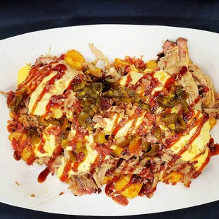 Tater Hogs- Tater Tots, Pulled pork, cheese sauce, Tangy Hawaiian BBQ, bacon, jalapenos